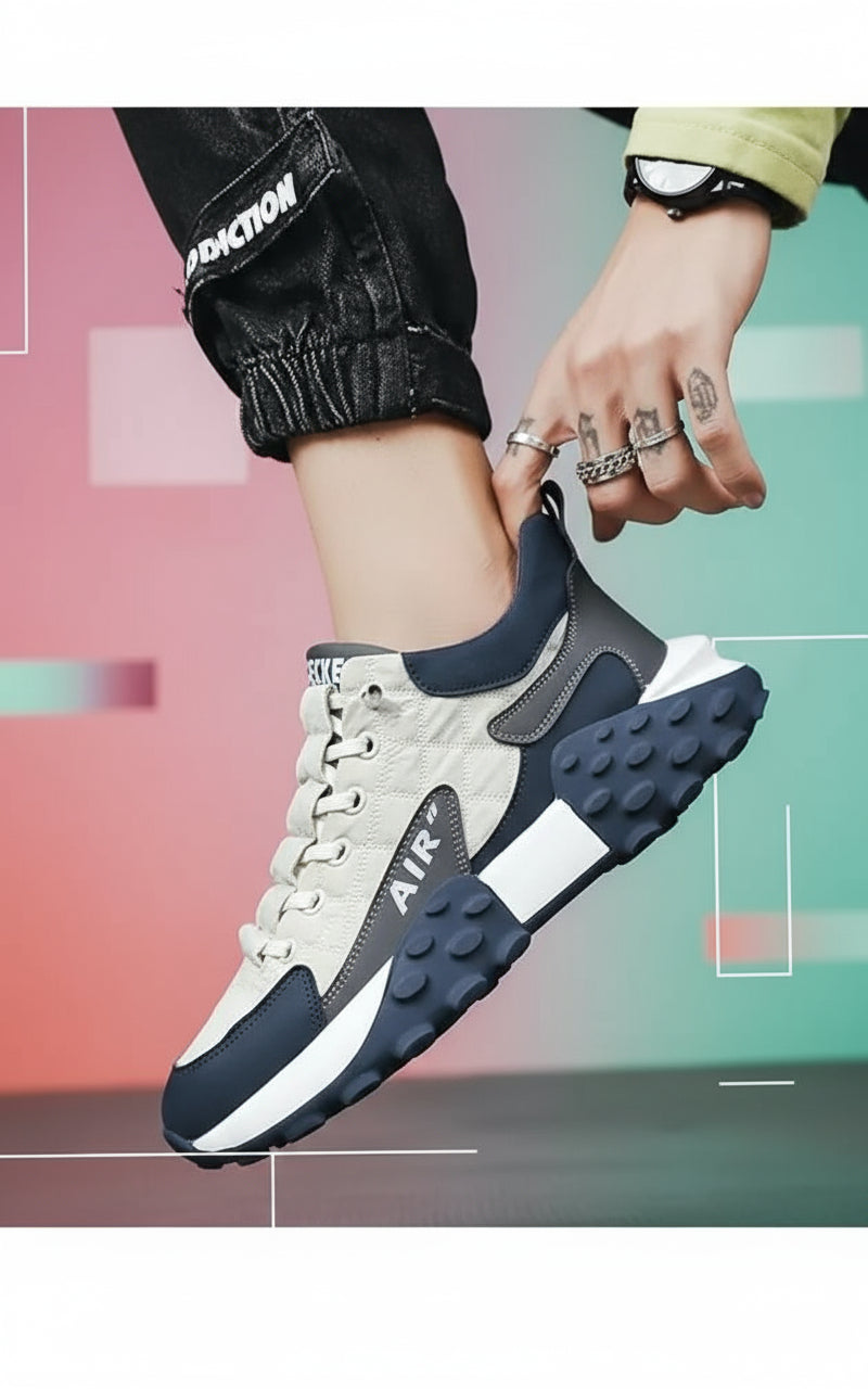 Close-up of a person wearing white and navy sneakers with 'Air' branding.