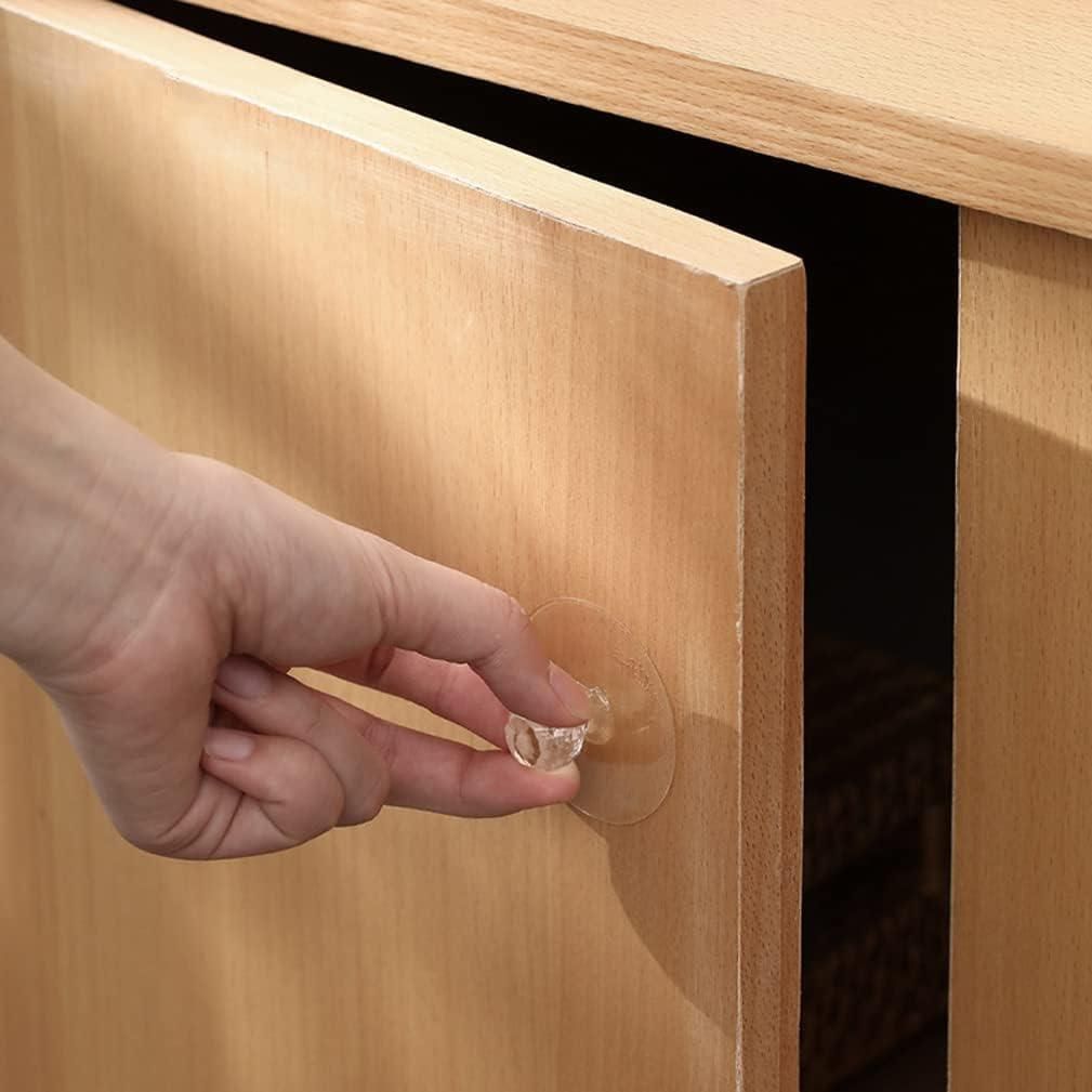 Hand applying a clear adhesive strip to a wooden surface