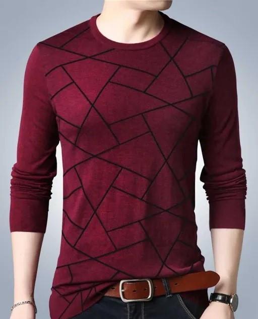 Maroon sweater with black geometric pattern worn by a person on a gray background