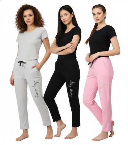 Three women wearing gray, black, and pink pajama sets with a visible brand name on a white background.