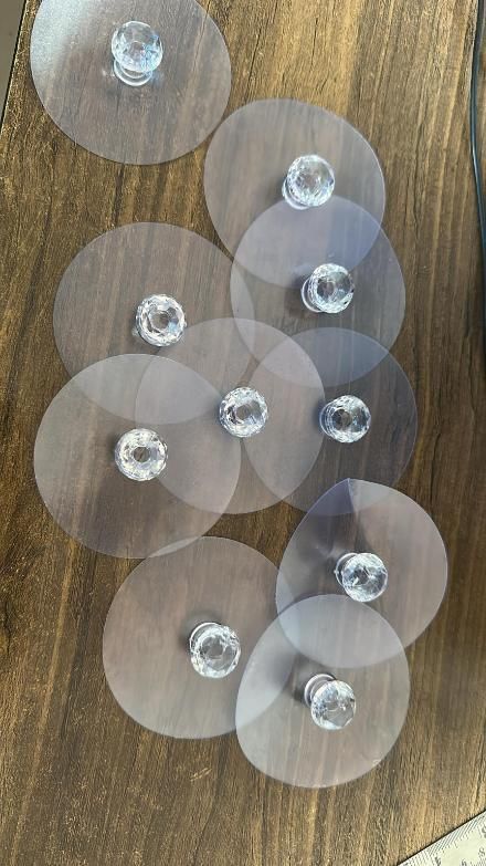 Clear adhesive pads with suction cups on a wooden surface