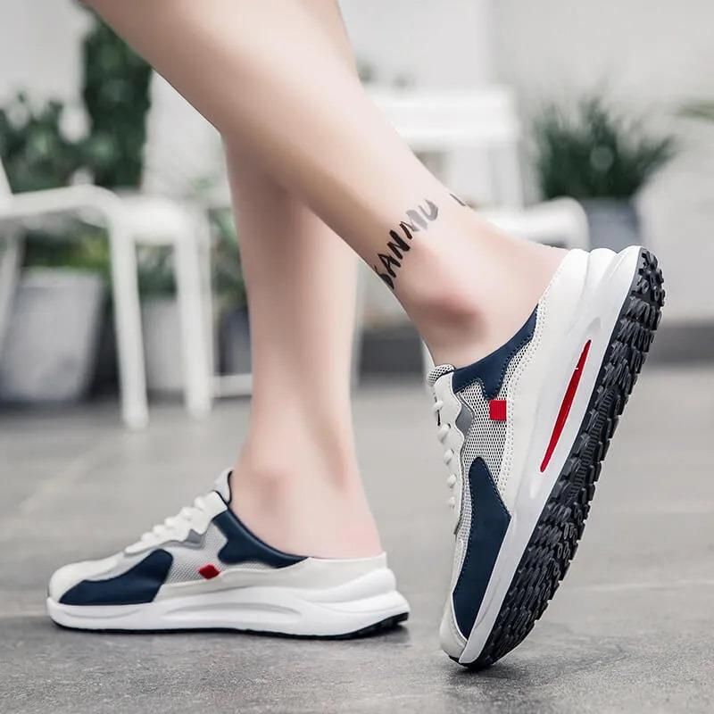 Person wearing blue and white sneakers with a red accent on a blurred indoor background